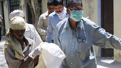 The beheaded body of Meenakshi Thapa, is taken from a residence in Allahabad on April 18.