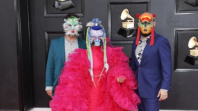 Li Saumet from Bomba Estereo, centre, wore a ruffled pink ensemble. EPA