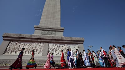 People pay their respects at the Monument to the People's Heroes on Martyrs' Day in Tiananmen Square, Beijing, China. EPA