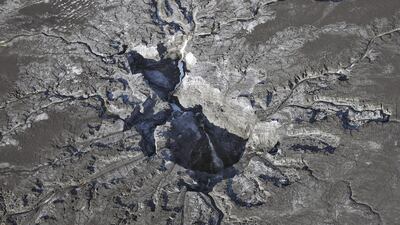 Water continues to flow into a large sinkhole on the Mosaic Co property shown in this aerial photo taken September 29, 2016, in Mulberry, Florida. Neighbours of the huge sinkhole, which is sending cascades of contaminated water and fertiliser plant waste into Florida’s main drinking-water aquifer, are fearful and fuming that it took weeks for them to be notified of the disaster. Many are still waiting anxiously for results from tests for radiation and toxic chemicals in their well water. Chris O’Meara / Associated Press