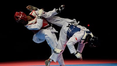 Thailand's Ramnarong Sawekwiharee, left, competes against Indonesia's Reinaldi Atmanegara during their men's under 54kg taekwondo semi-final match at the South East Asian Games in Kuala Lumpur. Mohd Rafsan / AFP Photo