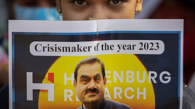 An activist holds a placard denouncing billionaire Gautam Adani during a protest in New Delhi. Reuters