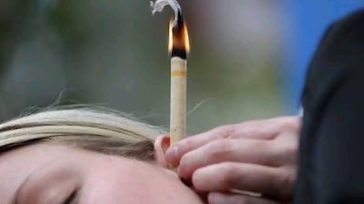 Ear candling is meant to remove wax by drawing it up through a hollow candle.
