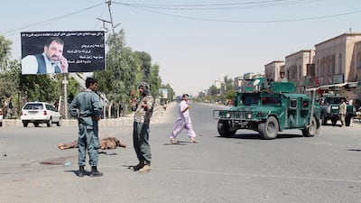 Afghan security forces attend the aftermath of a suicide attack in Kandahar in July. Police in the southern Afghanistan province, the heartland of the Taliban, have improved security but have also been criticised for taking the law into their own hands for their heavy-handed tactics. Javed Tanveer / AFP