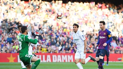 Lionel Messi chips the goalkeeper in an attempt to score. Getty Images