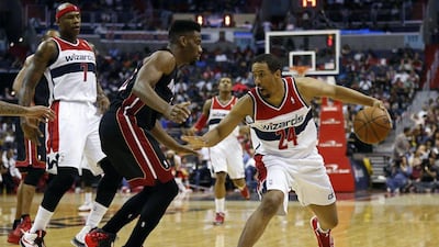 Washington Wizards guard Andre Miller, right, dribbles the ball as Miami Heat forward Udonis Haslem, centre, defends in the second quarter at Verizon Center. Geoff Burke / USA TODAY Sports