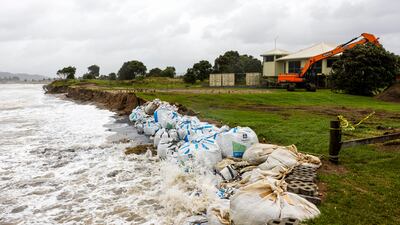 Sand bags are placed along the coastline as Cyclone Gabrielle buffets the Coromandel, south of Auckland. AP