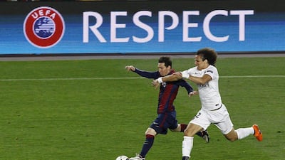 Paris Saint-Germain defender David Luiz tries to track down Lionel Messi on Tuesday night during their Champions League quarter-final second leg contest. Quique Garcia / AFP / April 21, 2015