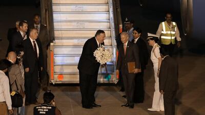 Mike Pompeo receives a bouquet of flowers as he arrives at Air Force Station Palam in Delhi, India. Bloomberg