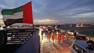 Rashed Mubarek Al Mansoori leads a parade of family and friends back to his camp after Al Dhafra, his six-year-old female, took first place in the buying class at the Al Dhafra Festival at Madinat Zayed, Al Gharbia in 2012. (Jeff Topping /The National / December 20, 2012)