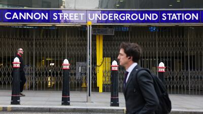 A commuter passes a closed entrance to Cannon Street underground station. Bloomberg