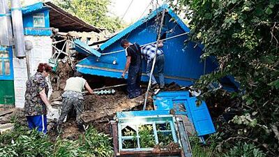 Residents in Krymsk, the worst-hit area of the Russian flash floods, search for survivors. At least 150 people have died in the region.