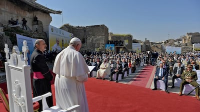 Pope Francis, surrounded by religious dignitaries at a square near the ruins of the Syriac Catholic Church of the Immaculate Conception. AFP