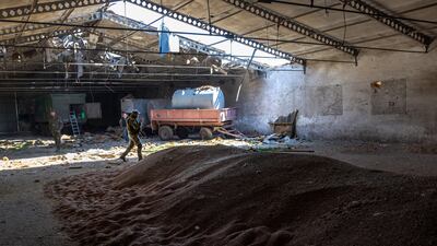 Ukrainian soldiers inspect a grain warehouse damaged in shelling by Russian forces in the Kherson region. Getty