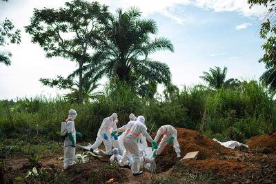 Workers bury the remains of Mussa Kathembo, an Islamic scholar who had prayed over those who were sick and died of Ebola in Beni, DRC. AP