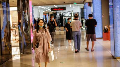 Shoppers at a mall in Beijing's Central Business District area. The pandemic situation in China is still 'severe and complex', and the negative impact of coronavirus controls on the economy is still pronounced. EPA