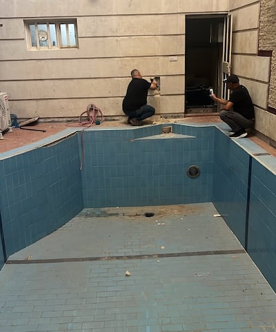Investigators using drill hammer to break through a wall at the home of the arrested Deputy Oil Minister Ali Maarij Al Bahadly to reach the hidden funds. Source: Iraq's Supreme Judiciary Council.