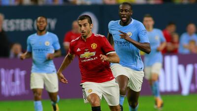 Manchester United's Henrikh Mkhitaryan in action with Manchester City's Yaya Toure. Richard Carson / Reuters