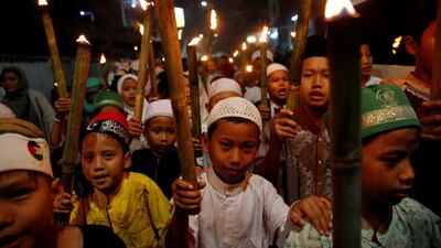 Muslim children carry torches as they take part during a parade ahead of Ramadan at a rural area in Jakarta, Indonesia. Reuters