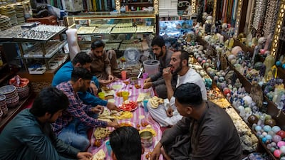 Adam Abd Al Rahman has iftar in his shop in Deira near the gold souq with co-workers. All photos: Antonie Robertson / The National