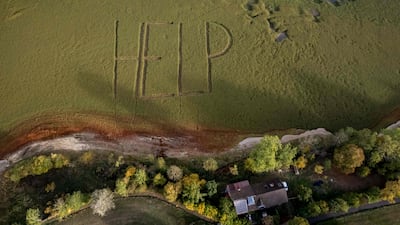 A giant 'Help' written by residents on the grass-covered bed of the Doubs river in Switzerland, which dried up in July. AFP