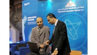 Egyptian national Ahmed Mohammed, right, working with a colleague at an exhibition stand in the Mishref Fair Grounds in Kuwait. He says: 'You can have the same lifestyle in Egypt as you can here, but it's very difficult to find.'