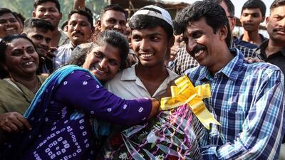 Pranav Dhanawade, centre, celebrates his 1,009 runs innings with his father Prashant Dhanawade (R) and Mohini Dhanawade (2-L) after HT Bhandari Cup inter-school tournament, in Kalyan outskirts of Mumbai, India, 05 January 2016. Divyakant Solanki / EPA