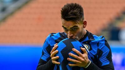 Inter Milan's Lautaro Martinez kisses the ball after scoring a hat-trick against Crotone. AFP