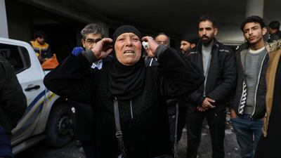 Outside Sednaya prison, a woman voices frustration as people search for relatives they believe are held in concealed cells. Getty Images
