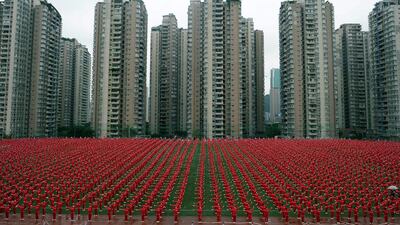 People dance at a football court to challenge the Guinness World Record of the most people dancing square dance at the same time, in Chongqing Municipality, China. Stringer / Reuters