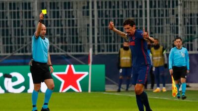 Atletico Madrid's Stefan Savic is shown a yellow card. Reuters