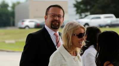 Adviser Sebastian Gorka (L), one of US president Donald Trump's most outspoken defenders, left the White House late on Friday. Here he is waiting for Mr Trump to arrive to board Air Force One on July 25, 207. Jonathan Ernst / Reuters