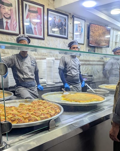 Queues curl around the street outside the shop for a bite of kunafa from the seven-decade-strong family sweet business. Hayley Kadrou / The National
