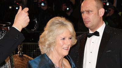 The queen consort, in a teal gown, arrives at the Royal World Premiere of Alice In Wonderland on February 25, 2010, in London. Getty Images