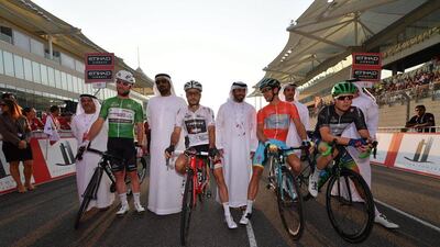 Left to right, Mark Cavendish in the green points jersey, Julien Bernard the white young rider jersey, Tanel Kangert in the red leader’s jersey, Jens Keukeleire in the black intermediate sprint jersey. Luca Zennaro / EPA