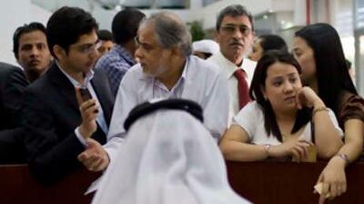People attempt to apply for the new ID card at the Emirates Identity Authority at the Dubai Central Post Office.