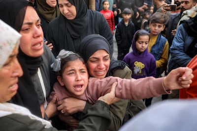 A young woman mourns for her siblings and other members from the Abu Al Rous family, who were killed when their house was hit by Israeli bombardment, during the funeral at the Bureij camp for Palestinian refugees in the central Gaza Strip on March 25. AFP