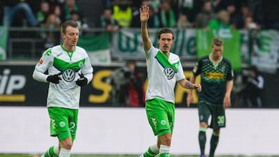 Wolfsburg's striker Max Kruse, centre, celebrates scoring his side's second goal during the German first division Bundesliga football match of VfL Wolfsburg v Borussia Moenchengladbach in Wolfsburg, on March 5, 2016. AFP / ODD ANDERSEN