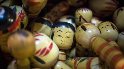 Traditional Kokeshi dolls from Japan’s northern Tohoku area are piled up in a box at Boroichi flea market in Tokyo. Thomas Peter / Reuters