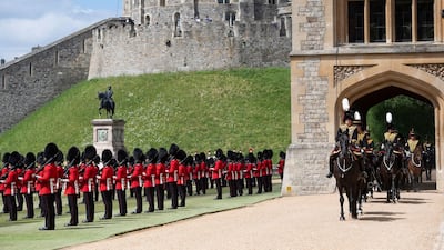 Members of the Household Cavalry, right, arrive as members of the F Company Scots Guards stand to attention. AFP