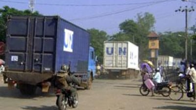 Sri Lankan army soldiers on a motorcycle escort a United Nations food convoy travelling through Vavuniya on Dec 29 2008, heading to the Tamil rebel-held north of the island. The UN and the International Committee of the Red Cross are pushing food and other supplies to the region where some 300,000 civilians are trapped by the ongoing fighting between goverment forces and Tamil Tiger rebels.