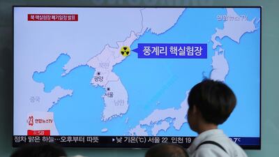 People watch a TV screen reporting that North Korea will dismantle nuke test site during a news programme at the Seoul Railway Station in Seoul. Ahn Young-joon / AP