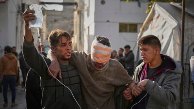 An injured man is taken to the Al-Ahli hospital following overnight Israeli army airstrikes across the Gaza Strip on Tuesday. AP