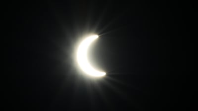 The partial eclipse appears over the UAE at Al Qudra Lakes, Dubai. Chris Whiteoak / The National
