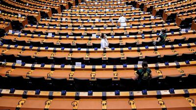 A sanitising crew clean the European Parliament chamber ahead of a plenary session sitting on Wednesday where details of the €750bn coronavirus bailout fund are set to be announced. AFP