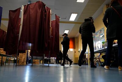 People vote in Paris in the first round of the presidential election, where up to 48 million voters will choose from 12 candidates. AP