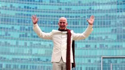 Jeff Bezos, founder and chief executive of Amazon, atop a supply truck at the premises of a shopping mall in Bangalore, India. The firm is trying to woo Indian consumers. Abhishek N. Chinnappa/Reuters
