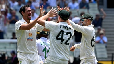 Australian bowler Mitchell Starc, left, celebrates dismissing South African batsman Temba Bavuma. AFP