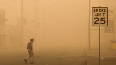 A man walks through a haze of smoke in Molalla, Oregon. Reuters