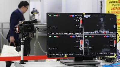 A quarantine station measures passenger body temperatures at Narita Airport. AFP